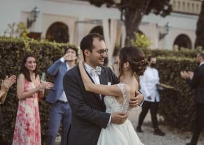 Gli sposi si abbracciano e si guardano mentre gli invitati applaudono